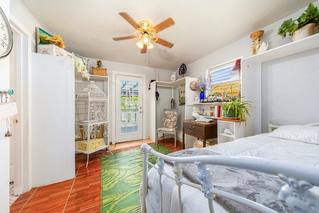 bedroom with access to outside, a textured ceiling, wood-type flooring, and ceiling fan