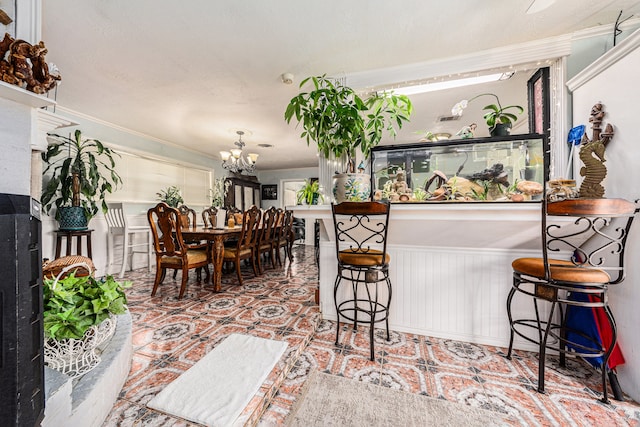 interior space featuring a notable chandelier and a kitchen bar