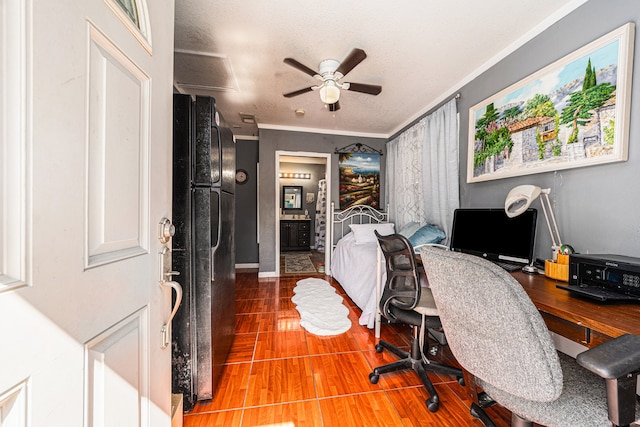 office area featuring ceiling fan, a textured ceiling, ornamental molding, and wood-type flooring