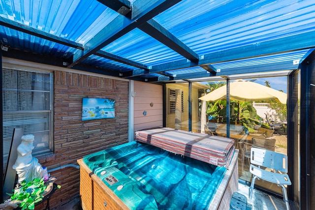 wooden deck featuring a hot tub and a pergola