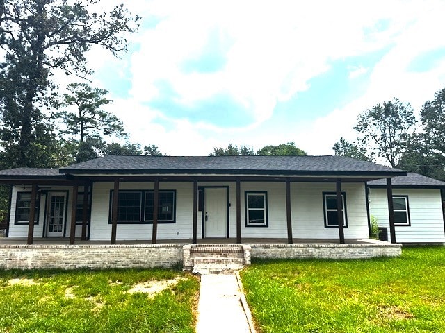 single story home with a front lawn and a porch