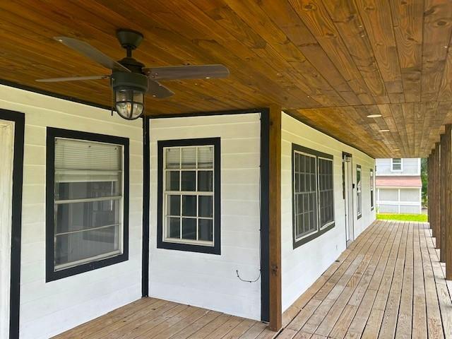 wooden deck featuring ceiling fan