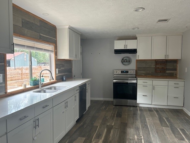 kitchen with dishwasher, sink, white cabinetry, stainless steel electric range oven, and dark wood-type flooring