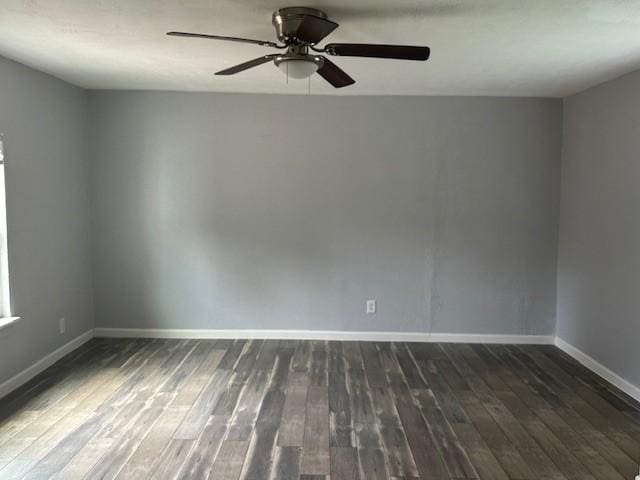 empty room featuring dark wood finished floors, baseboards, and ceiling fan