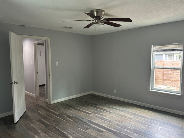 spare room featuring ceiling fan and dark hardwood / wood-style flooring