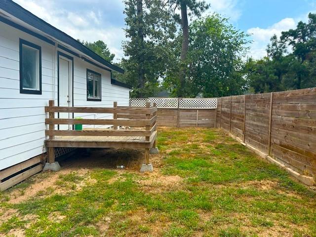 view of yard featuring a fenced backyard and a deck