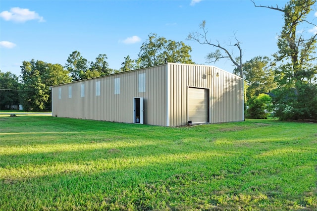 view of outbuilding with a yard