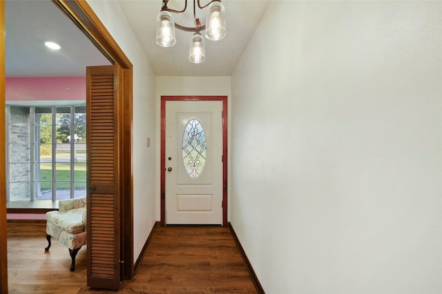 entryway featuring dark hardwood / wood-style floors and a notable chandelier