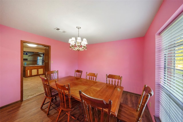 dining room featuring hardwood / wood-style flooring and a notable chandelier