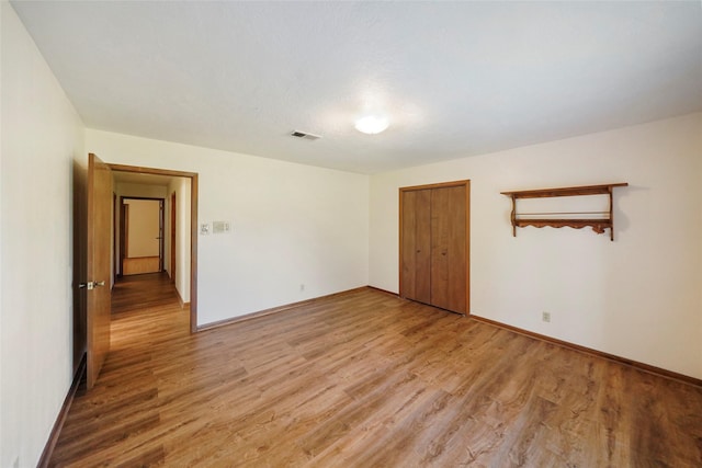 spare room with hardwood / wood-style floors