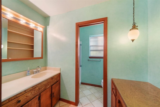 bathroom featuring vanity, tile patterned floors, and toilet