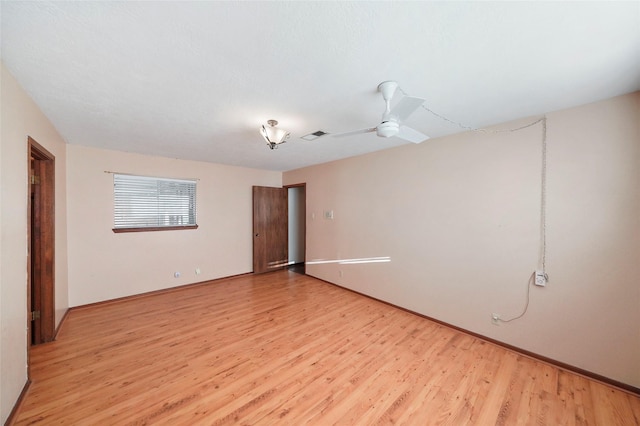 spare room with light hardwood / wood-style floors and ceiling fan