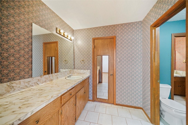 bathroom with tile patterned floors, vanity, and toilet