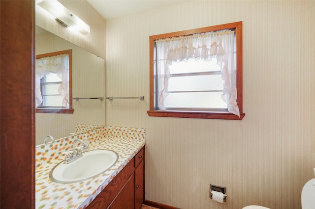 bathroom featuring vanity and toilet