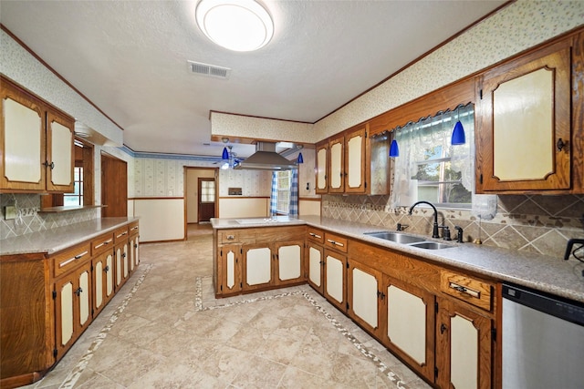 kitchen featuring wall chimney exhaust hood, sink, crown molding, dishwasher, and kitchen peninsula