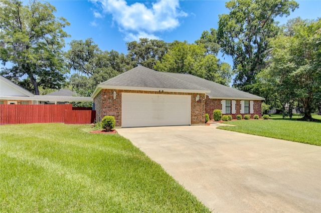 ranch-style home with a garage and a front lawn