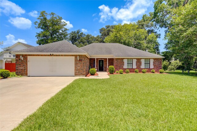 ranch-style house with a garage and a front yard