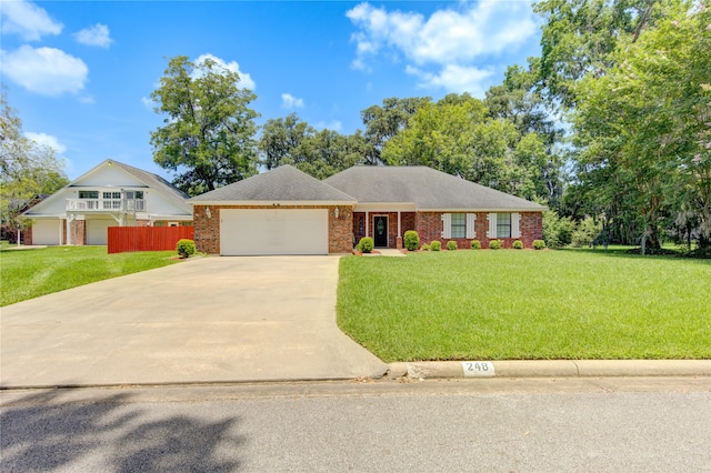 ranch-style home with a garage and a front lawn