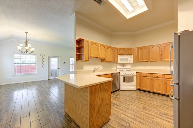 kitchen featuring pendant lighting, sink, kitchen peninsula, stainless steel appliances, and light wood-type flooring