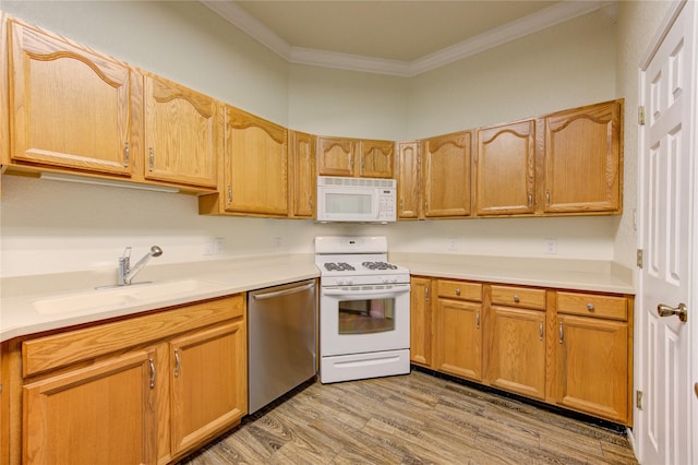 kitchen featuring white appliances, ornamental molding, light hardwood / wood-style floors, and sink