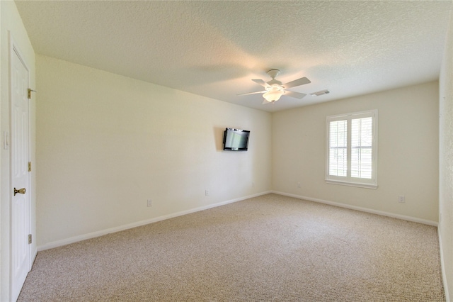 unfurnished room with ceiling fan, light carpet, and a textured ceiling