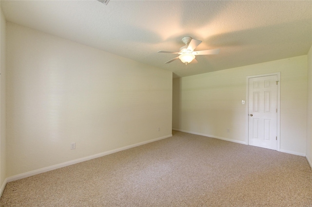 spare room with ceiling fan, carpet flooring, and a textured ceiling