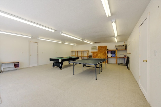 game room featuring billiards and a textured ceiling