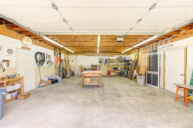 garage featuring a garage door opener and a workshop area