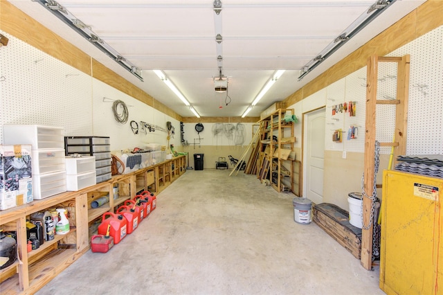 garage with a garage door opener and a workshop area