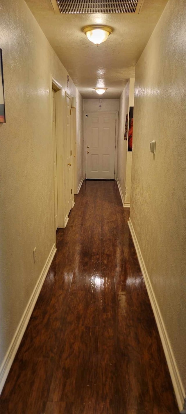 corridor featuring dark hardwood / wood-style flooring