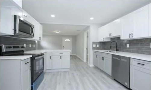 3437 Lydia St, Houston, TX 77021 - kitchen featuring stainless steel appliances, decorative backsplash, light countertops, light wood-type flooring, and recessed lighting