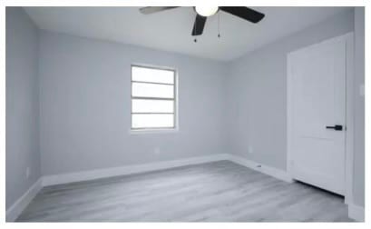 unfurnished room featuring light hardwood / wood-style floors and ceiling fan