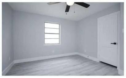 3437 Lydia St, Houston, TX 77021 - spare room featuring a ceiling fan, wood finished floors, and baseboards