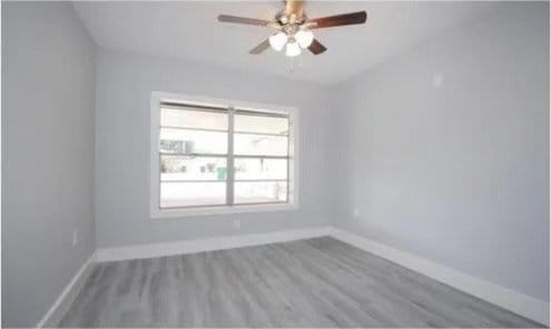 unfurnished room with hardwood / wood-style flooring and ceiling fan