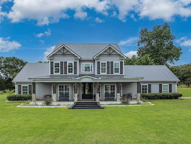 view of front facade with covered porch and a front yard