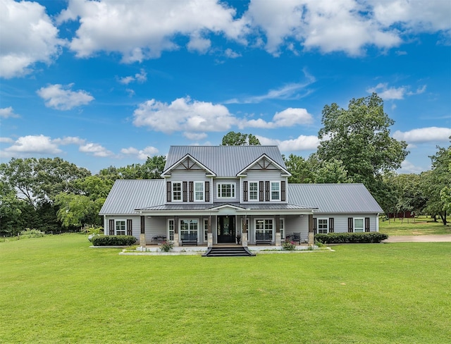 view of front of property with a porch and a front lawn