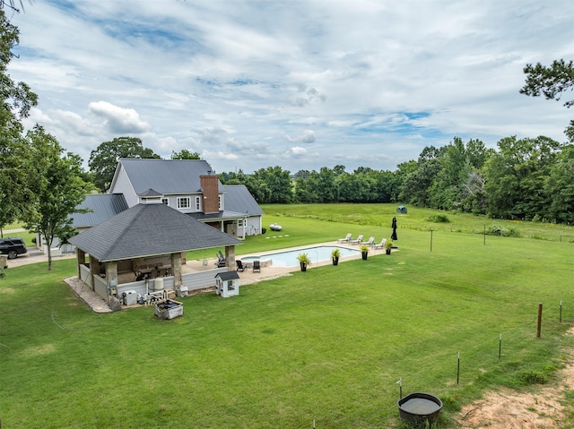 view of property's community with a yard, an outdoor bar, a patio area, and a swimming pool