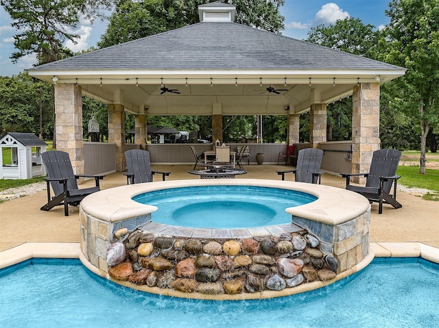 view of pool featuring a gazebo, ceiling fan, and a patio area