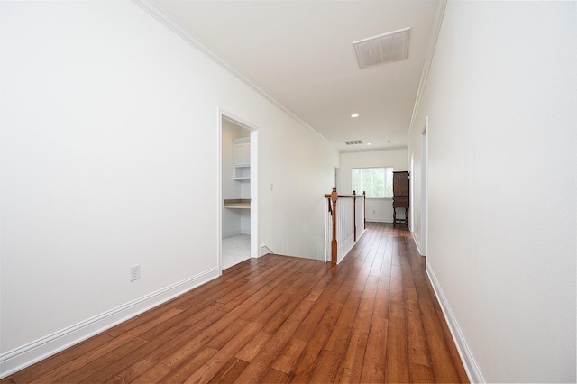 hall featuring ornamental molding and hardwood / wood-style flooring