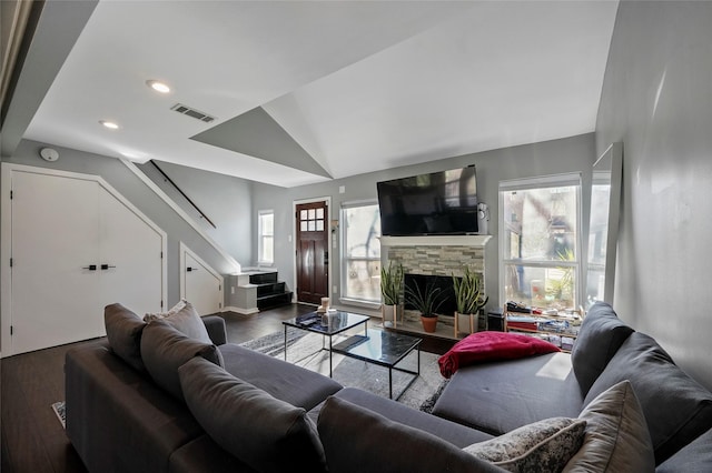 living room with hardwood / wood-style floors, a fireplace, and lofted ceiling