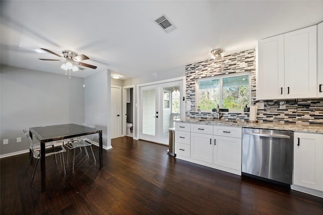 kitchen featuring white cabinets, dishwasher, decorative backsplash, sink, and light stone counters