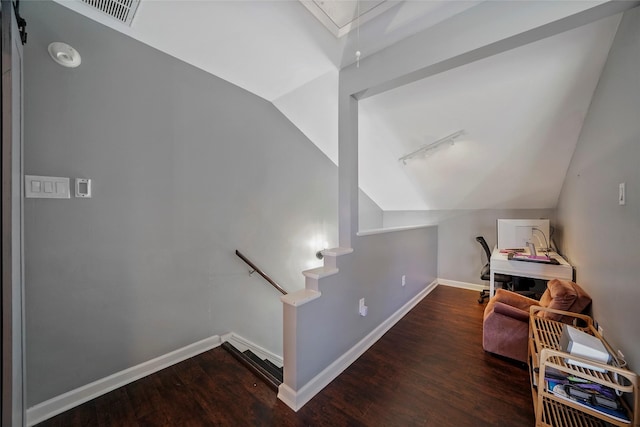 staircase with hardwood / wood-style flooring and vaulted ceiling