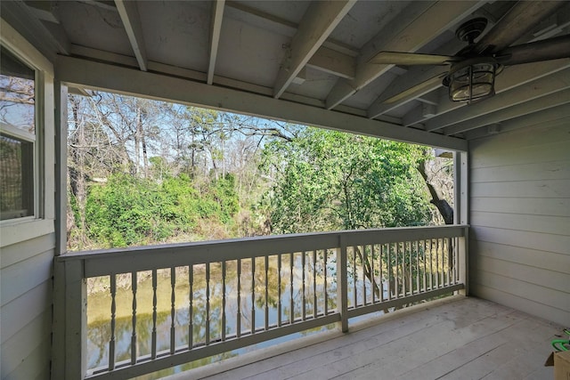 wooden deck featuring ceiling fan and a water view