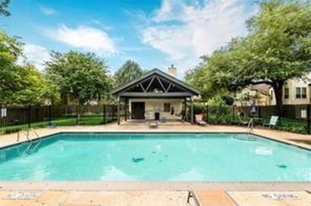 view of swimming pool with an outbuilding