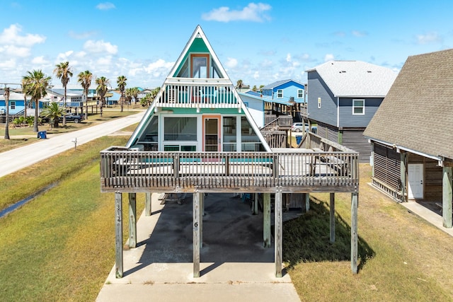312 Angel Wing, Surfside Beach, TX 77541 - back of property with a carport, a residential view, a yard, a wooden deck, and driveway