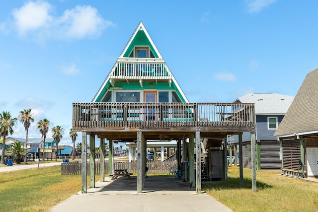 312 Angel Wing, Surfside Beach, TX 77541 - view of front of home with a carport, driveway, a front lawn, and a wooden deck