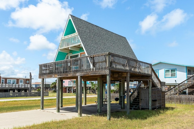 312 Angel Wing, Surfside Beach, TX 77541 - back of house featuring roof with shingles, stairway, a deck, a yard, and a carport