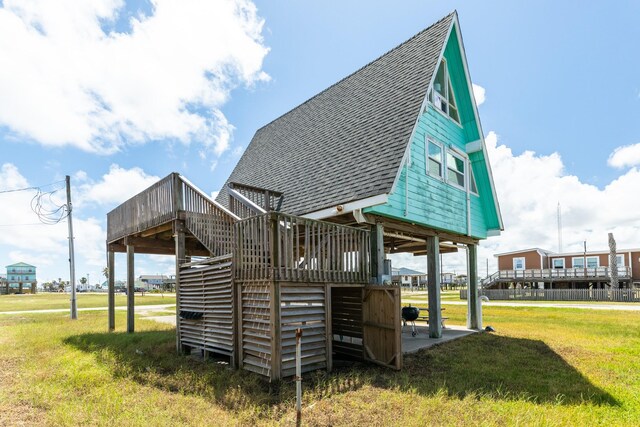 312 Angel Wing, Surfside Beach, TX 77541 - back of property with roof with shingles, a wooden deck, a yard, and stairway