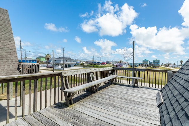 wooden deck featuring a yard