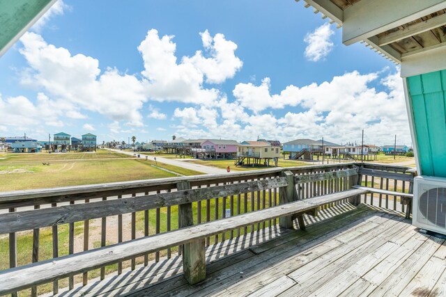 312 Angel Wing, Surfside Beach, TX 77541 - wooden terrace with a residential view, a cooling unit, and a yard